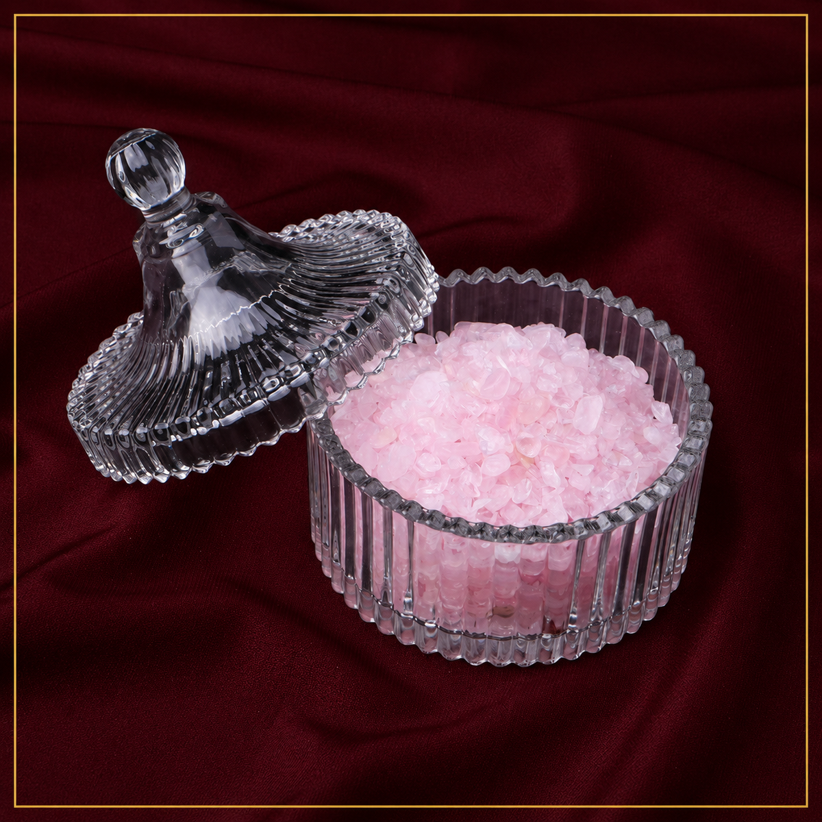 Top-down view of natural crystal cleansing bowl holding tumbled crystals and a mini tarot deck.