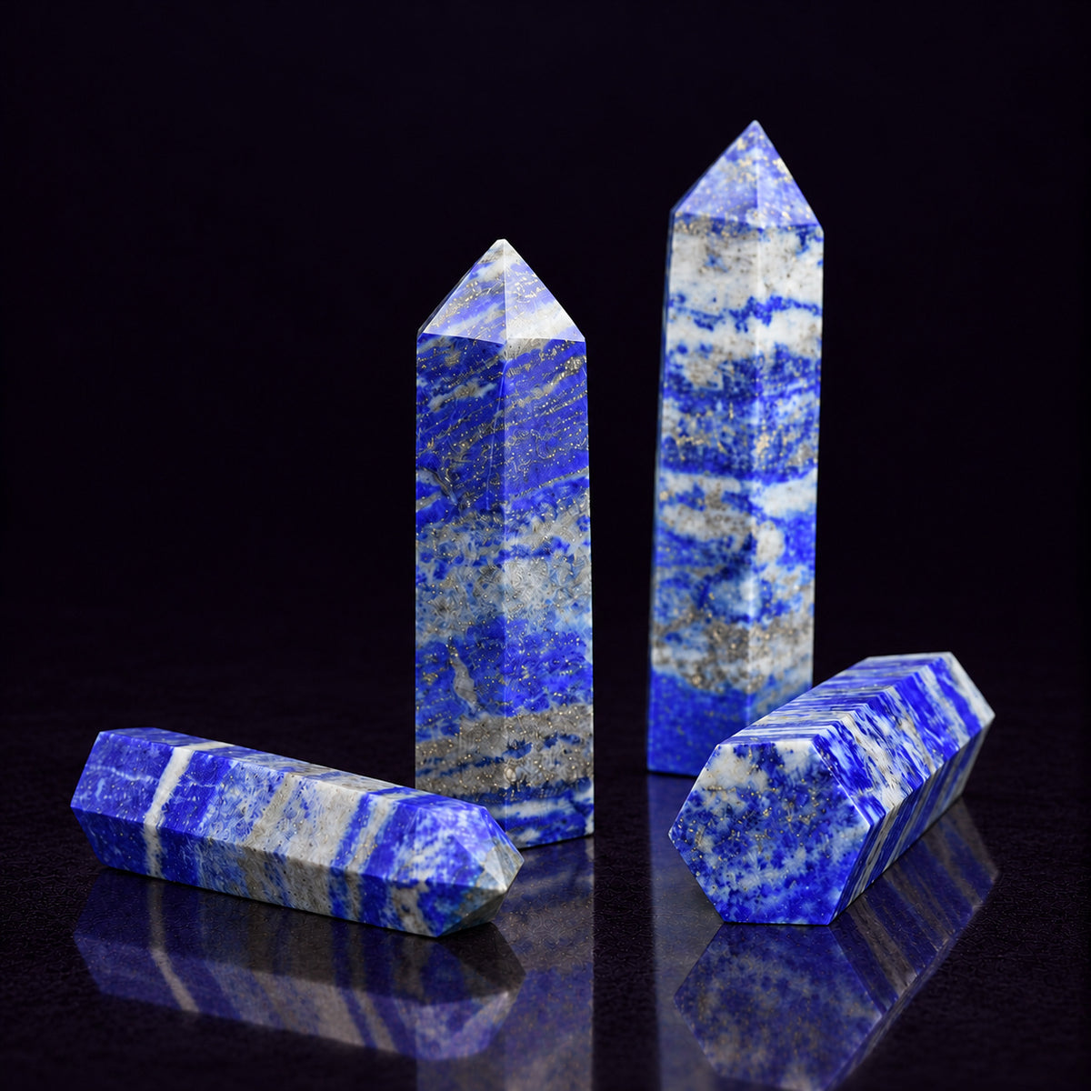 Lapis Lazuli crystal tower dimensions measuring approximately 7–9 cm (2.8–3.5 in) held in hand.
