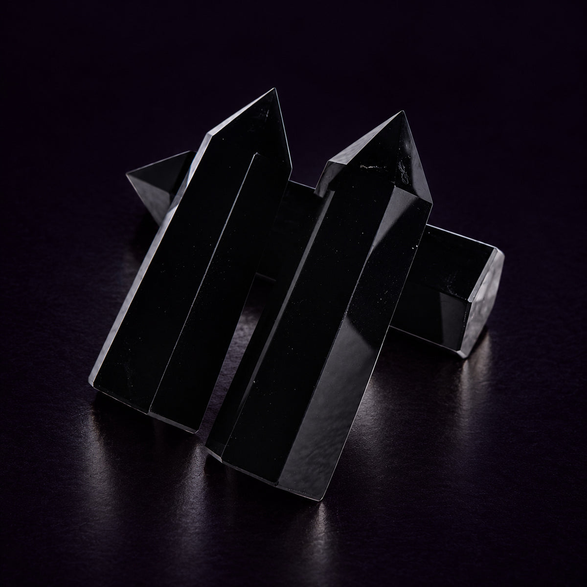 Black Obsidian crystal tower height comparison measuring approximately 7–9 cm (2.8–3.5 in) in hand.