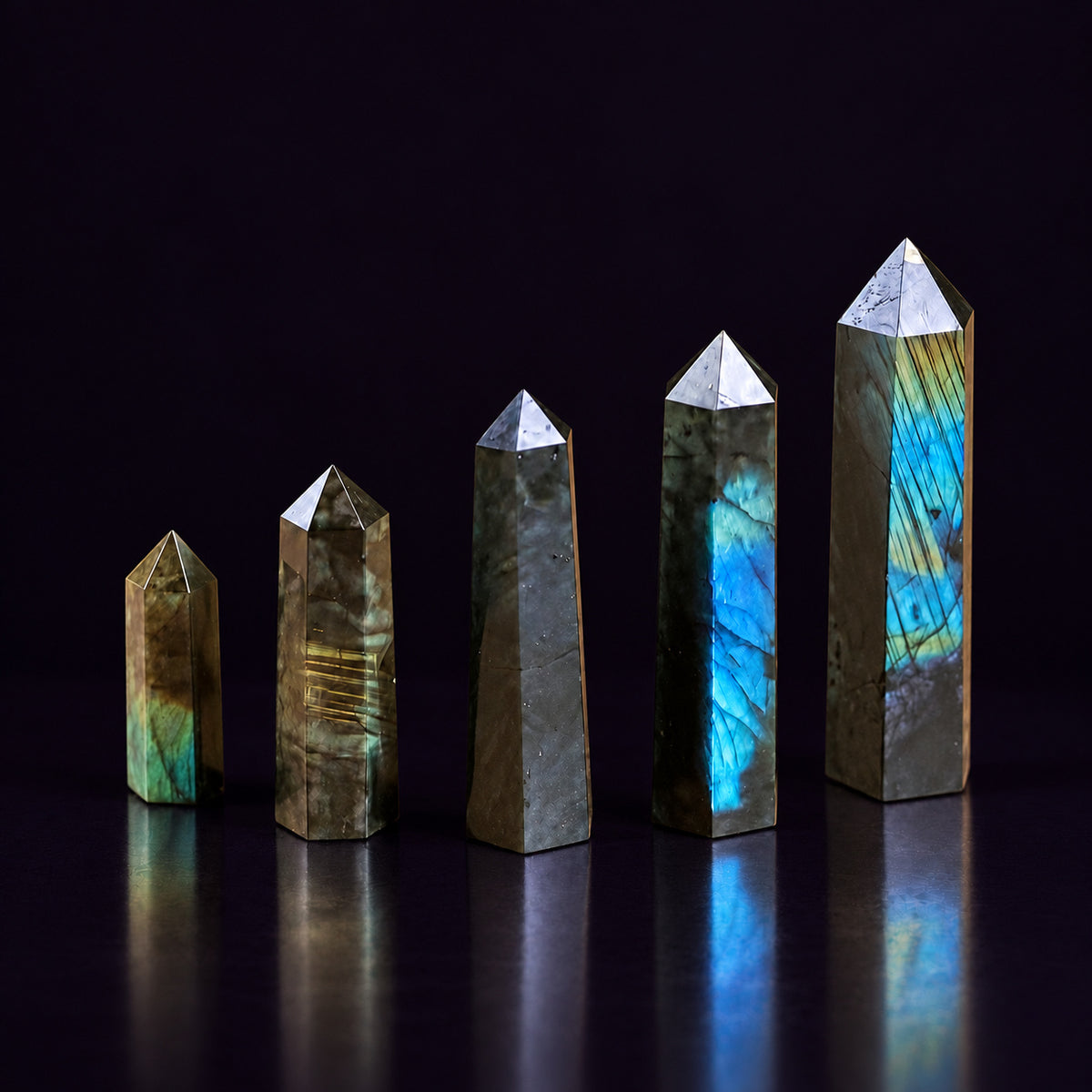 Polished hexagonal facets and apex of the Labradorite crystal wand for transformation and aura shielding.