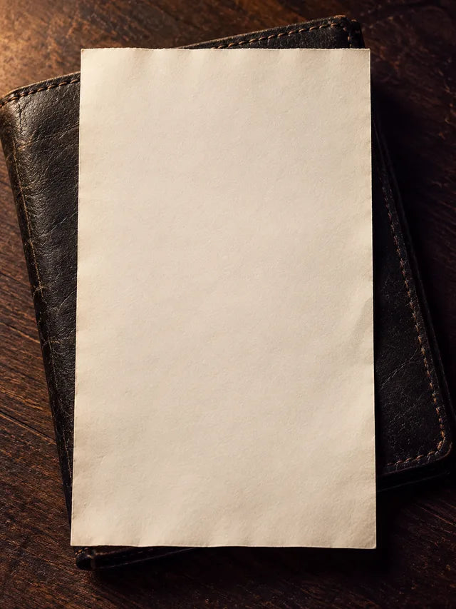 A blank paper receipt on a leather wallet